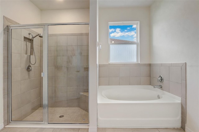 bathroom featuring plus walk in shower and tile patterned floors