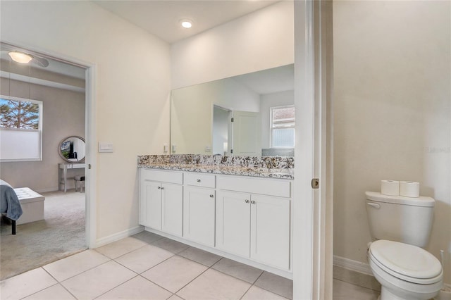 bathroom with tile patterned flooring, vanity, and toilet