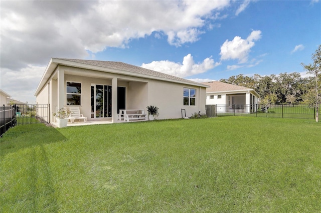 back of property with a yard and central AC unit