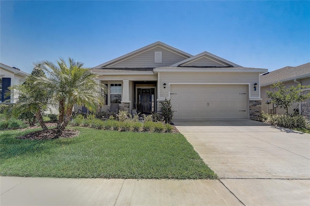 view of front of house featuring an attached garage, stone siding, driveway, and a front yard