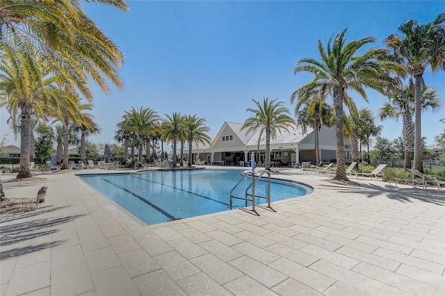 7889 Penrose Pl, Wildwood, FL 34785 - community pool with a patio and fence