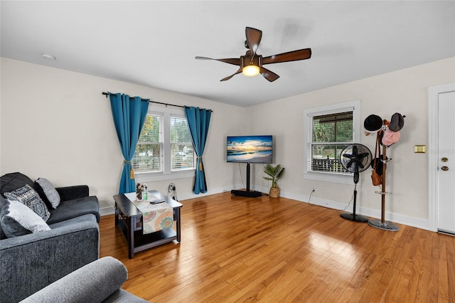 living room with hardwood / wood-style flooring and ceiling fan