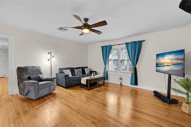 living room with ceiling fan and light wood-type flooring