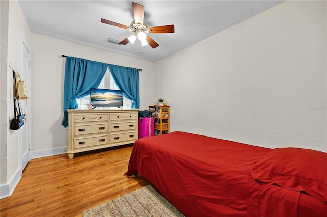 bedroom with ceiling fan and light wood-type flooring