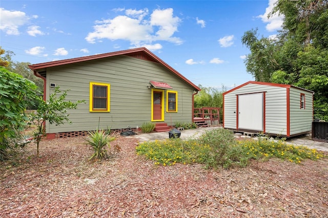 view of front facade with a storage shed