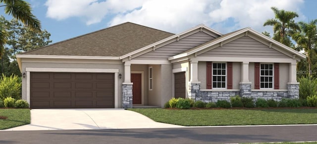 craftsman-style home featuring a front lawn and a garage