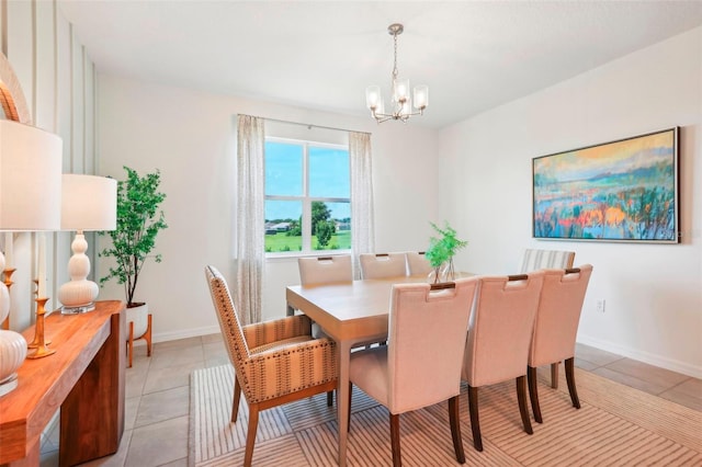 tiled dining space with a chandelier