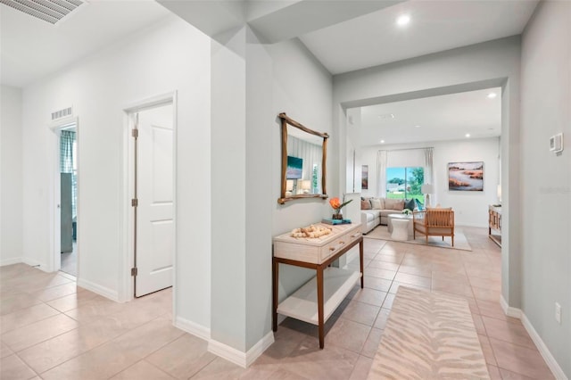 hallway with plenty of natural light and light tile patterned flooring