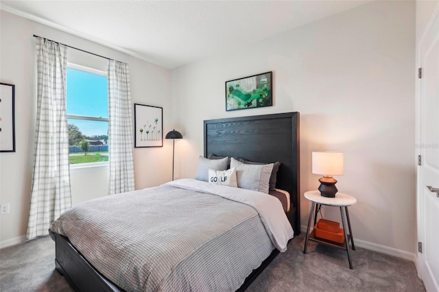 bedroom with dark colored carpet