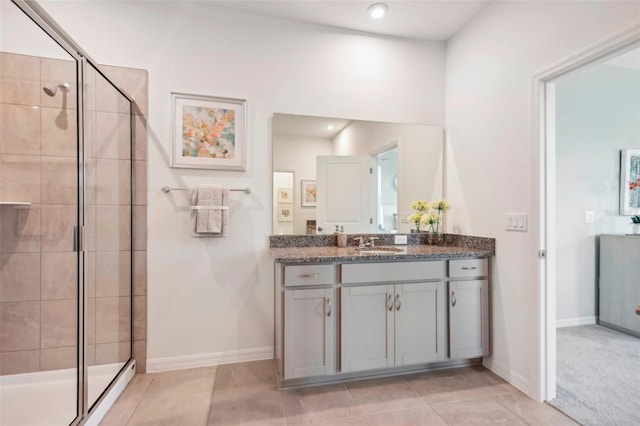 bathroom featuring an enclosed shower, vanity, and tile patterned floors