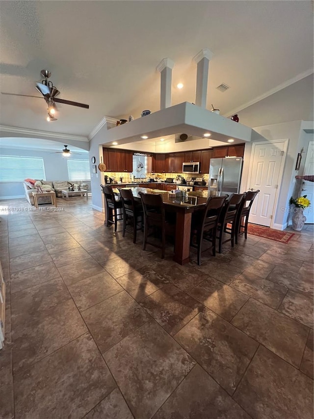 dining room with ceiling fan and crown molding