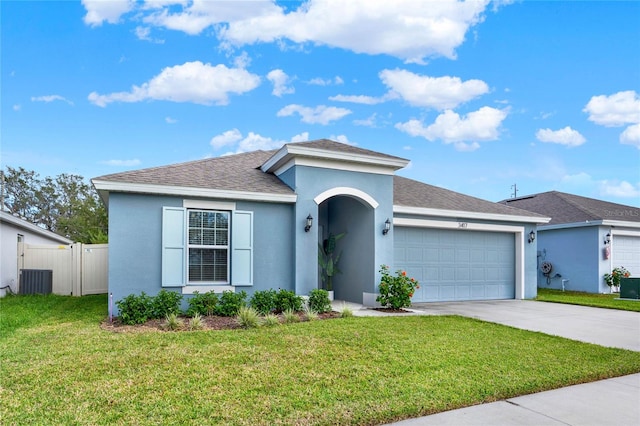 view of front of house with a garage and a front lawn