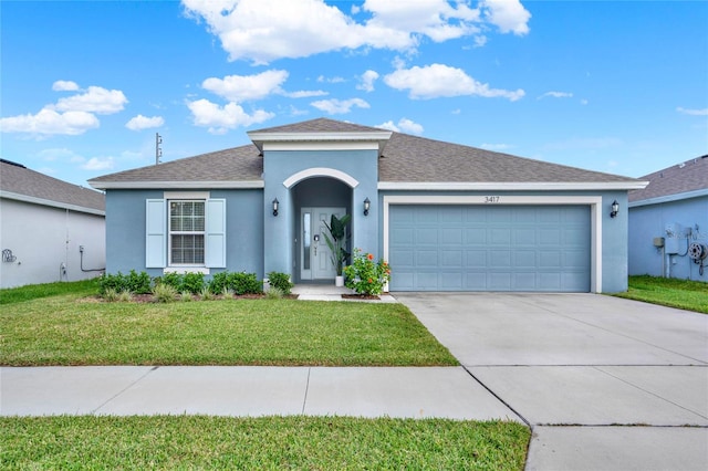 single story home with a garage and a front lawn