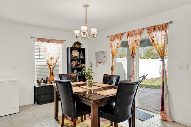 tiled dining space with an inviting chandelier