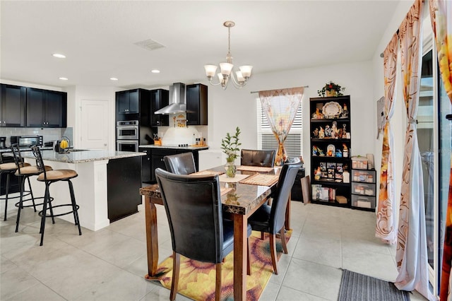 tiled dining space with a chandelier