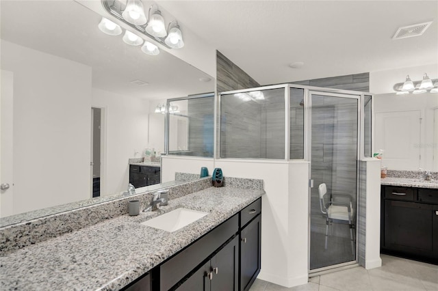 bathroom featuring vanity, tile patterned floors, and an enclosed shower