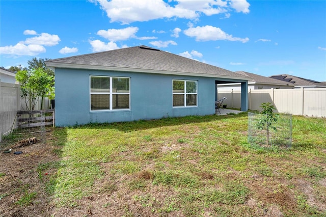 rear view of house with a yard