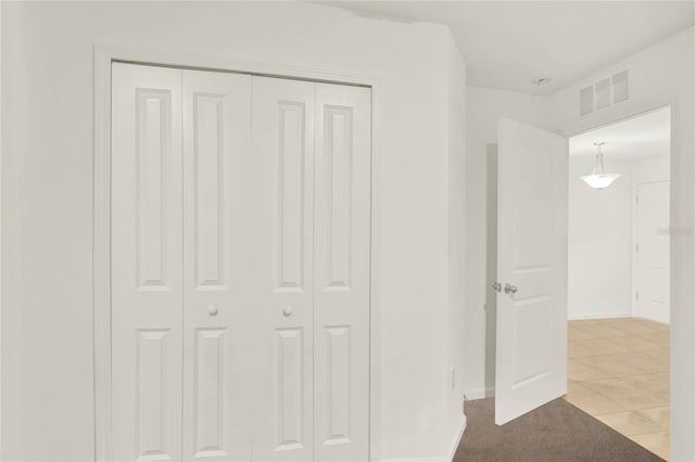 unfurnished bedroom featuring light tile patterned floors and a closet