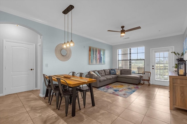 dining area featuring ornamental molding, ceiling fan, and light tile patterned flooring