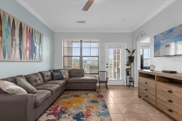 living room with ceiling fan, light tile patterned floors, and ornamental molding