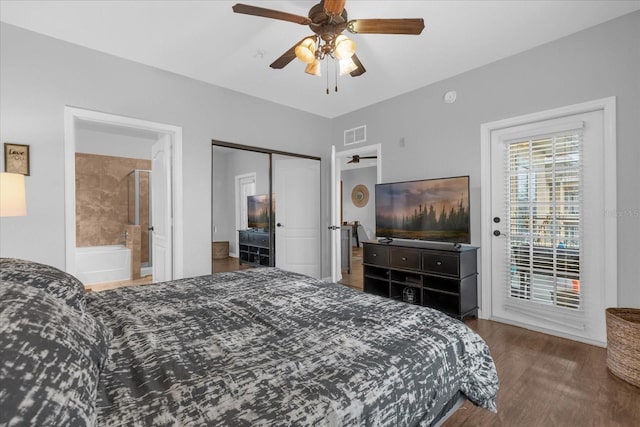 bedroom with access to exterior, connected bathroom, ceiling fan, dark hardwood / wood-style floors, and a closet