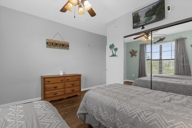 bedroom with dark hardwood / wood-style flooring and ceiling fan