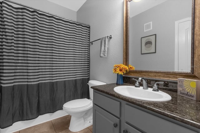 bathroom featuring tile patterned flooring, vanity, and toilet