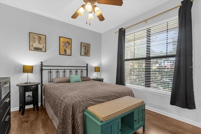 bedroom with ceiling fan and dark hardwood / wood-style flooring