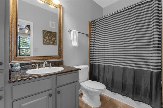 bathroom with toilet, vanity, tile patterned flooring, and ceiling fan