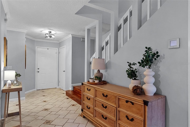 foyer entrance featuring a textured ceiling and crown molding