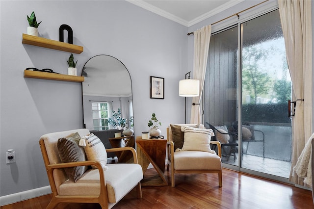 living area with hardwood / wood-style flooring and crown molding