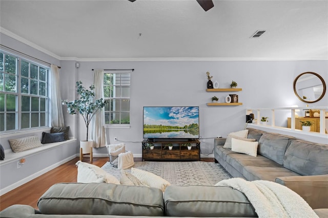 living room featuring light wood-type flooring, ceiling fan, and ornamental molding