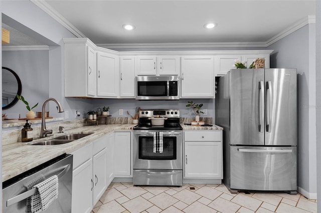 kitchen featuring crown molding, stainless steel appliances, white cabinetry, light stone countertops, and sink