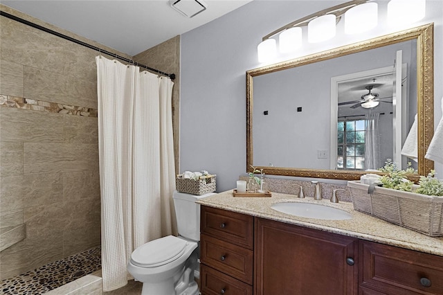 bathroom with toilet, vanity, ceiling fan, and a shower with shower curtain