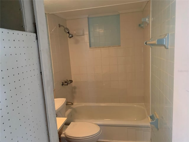 bathroom featuring tiled shower / bath and toilet