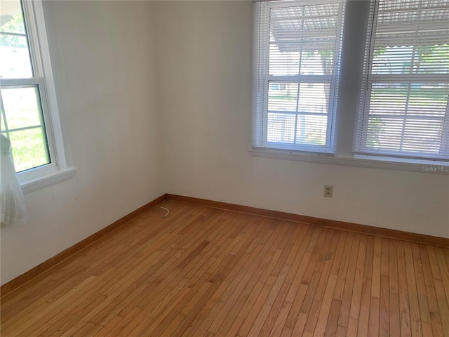 unfurnished room featuring a healthy amount of sunlight and light hardwood / wood-style floors