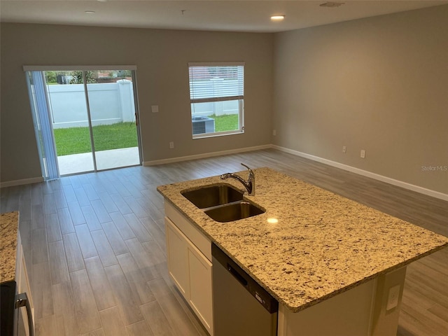 kitchen with a center island with sink, dishwasher, plenty of natural light, and sink