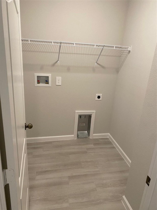 laundry room with electric dryer hookup, light hardwood / wood-style floors, and hookup for a washing machine