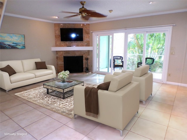 tiled living room with ceiling fan, a tile fireplace, a textured ceiling, and ornamental molding