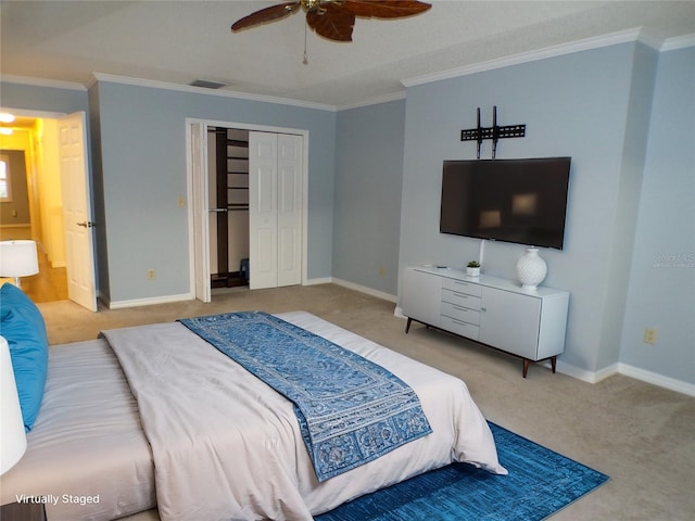 carpeted bedroom with ceiling fan, a closet, and ornamental molding