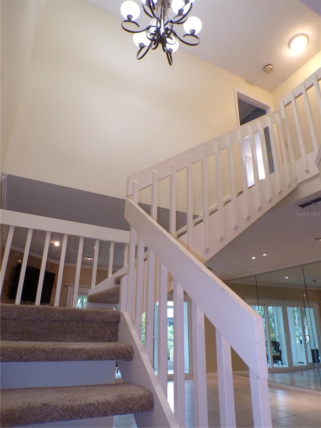 stairs with hardwood / wood-style floors and a notable chandelier