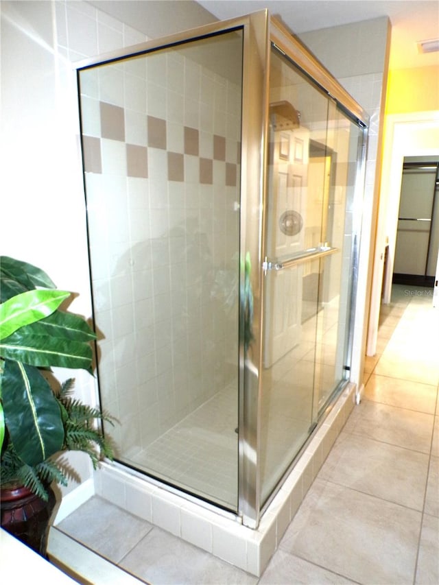 bathroom featuring walk in shower and tile patterned floors