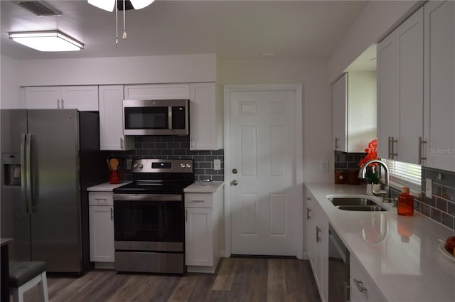 kitchen featuring white cabinetry, stainless steel appliances, sink, and dark hardwood / wood-style floors