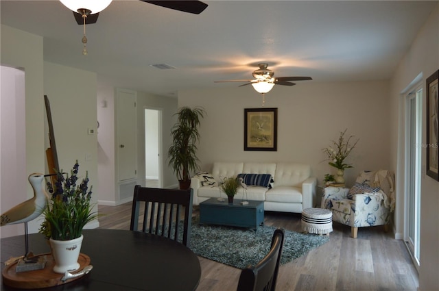 living room with hardwood / wood-style flooring and ceiling fan