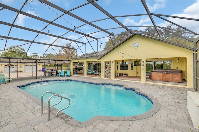 swimming pool with a hot tub, a patio, and a lanai