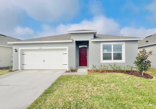 view of front of property with a garage and a front lawn