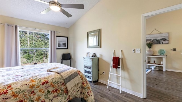 bedroom with a textured ceiling, vaulted ceiling, ceiling fan, and dark hardwood / wood-style flooring