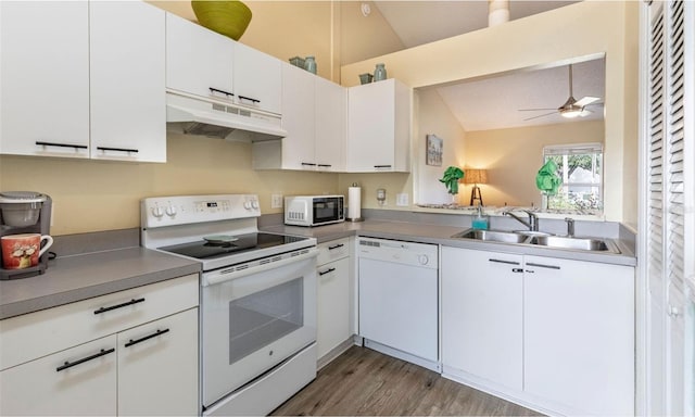 kitchen featuring sink, white cabinetry, white appliances, and lofted ceiling