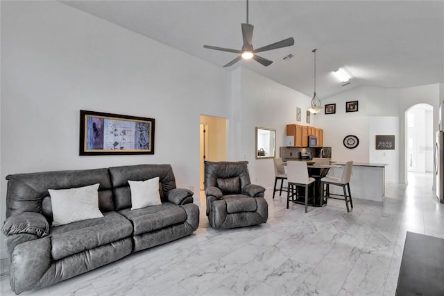 living room featuring high vaulted ceiling and ceiling fan