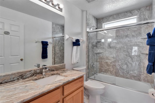 full bathroom with vanity, enclosed tub / shower combo, a textured ceiling, and toilet